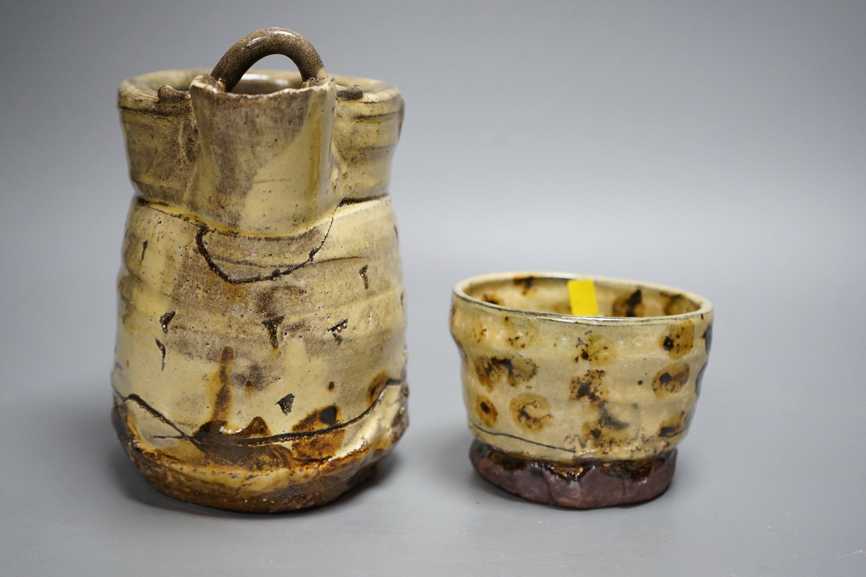 Jean-Nicolas Gérard (b.1954), a pale yellow and brown glazed earthenware jug and a similar bowl, with purchase receipt from Goldmark Gallery dated 09/04/2014, tallest 19.5cm, (2)